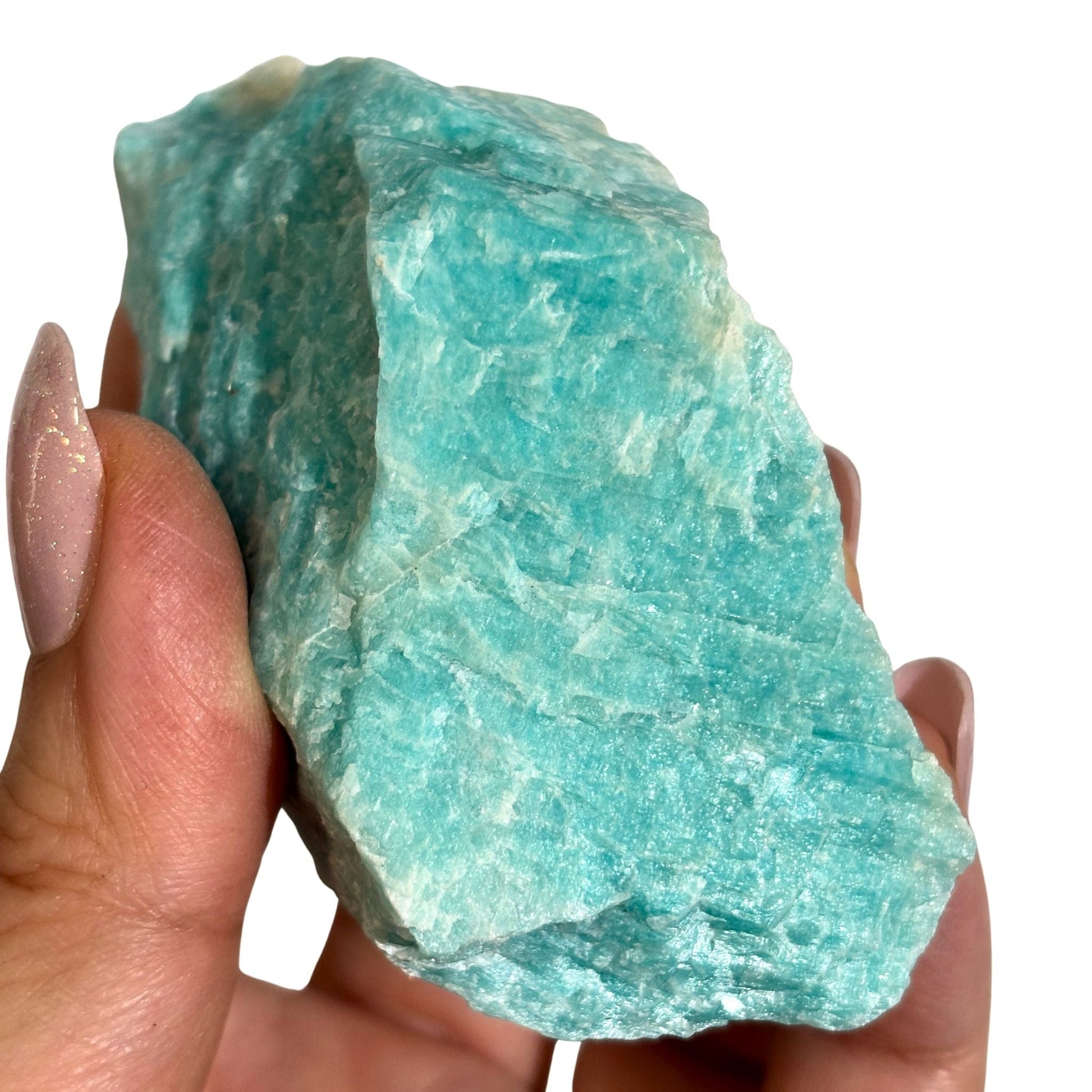 Raw amazonite close up in hand