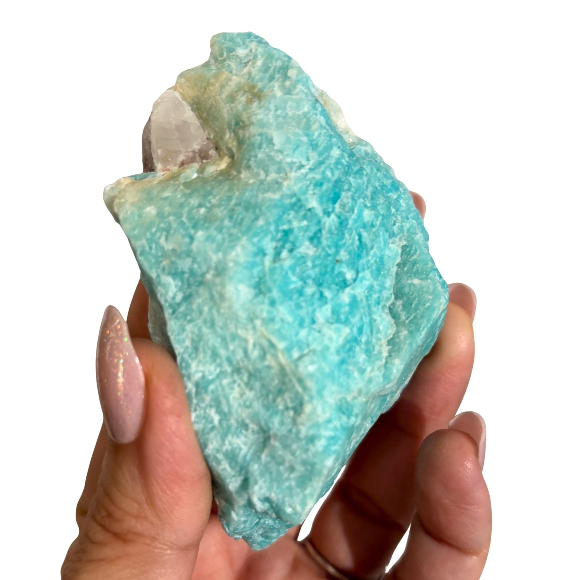 Raw amazonite in hand 