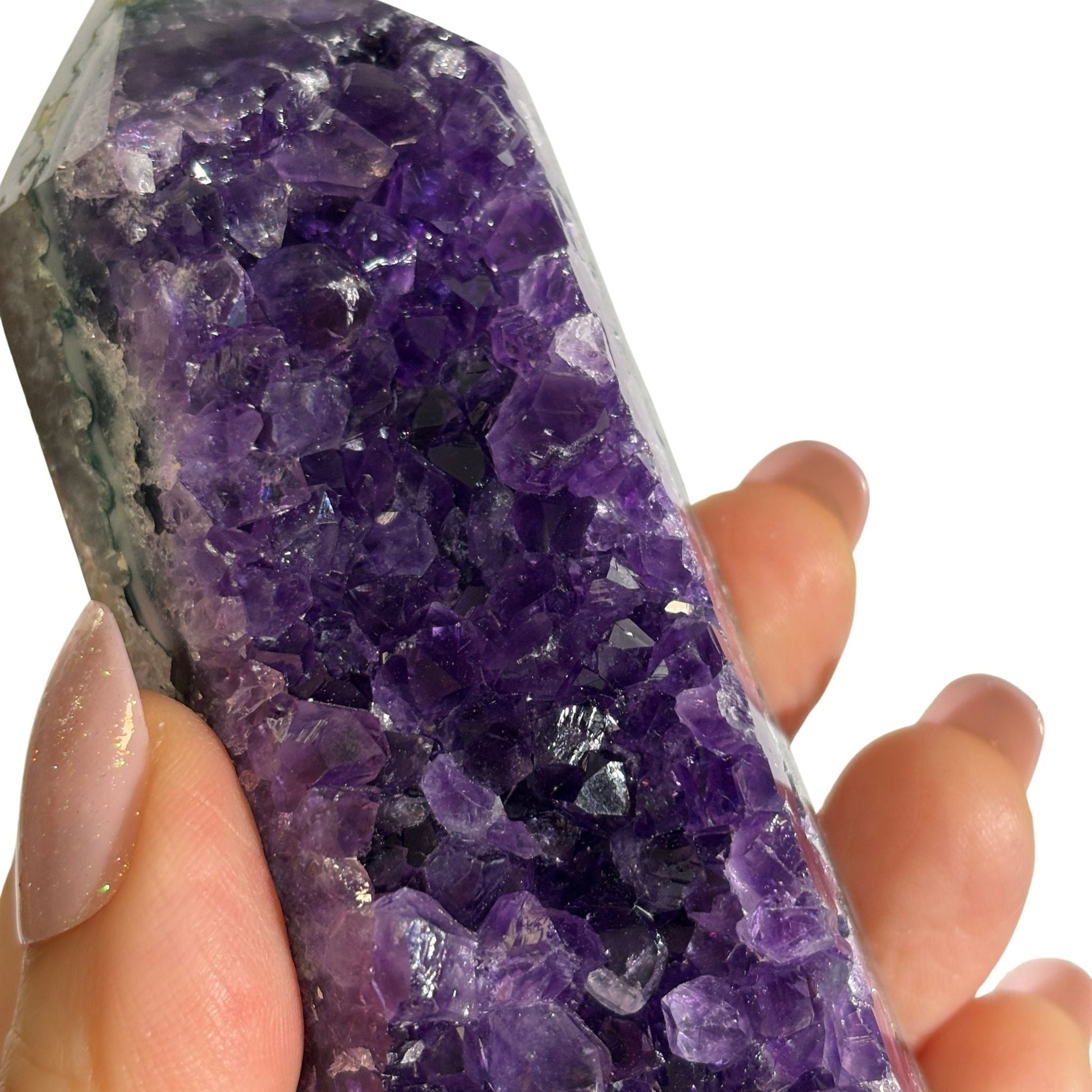 Amethyst geode tower close-up in hand