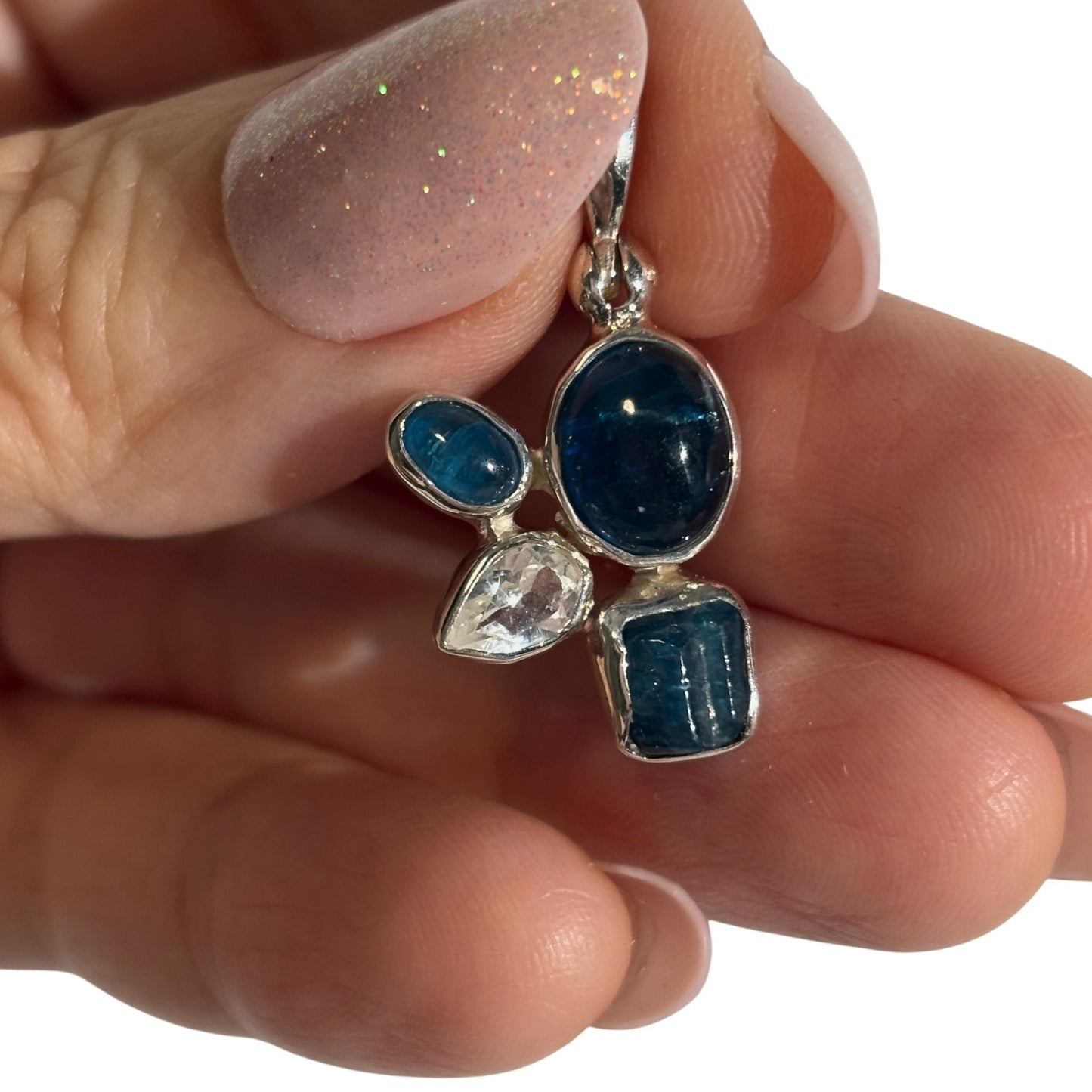 Blue apatite and white topaz pendant in hand