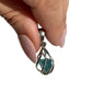Blue apatite silver swirl pendant in hand
