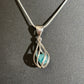 Blue apatite silver swirl pendant on chain black background