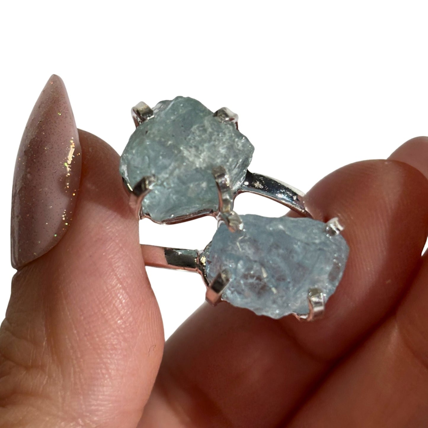 Raw aquamarine dual ring close-up in hand