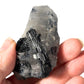 Black schorl tourmaline in quartz in hand 