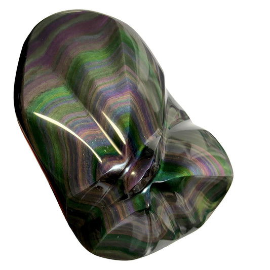 Multicolored raainbow obsidian stone with wavy pattern on a white background
