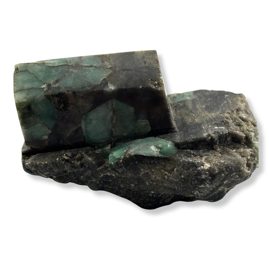 Polished rough emerald on rock 