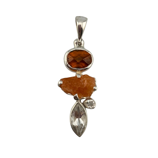 Silver pendant with orange garnets on a white background