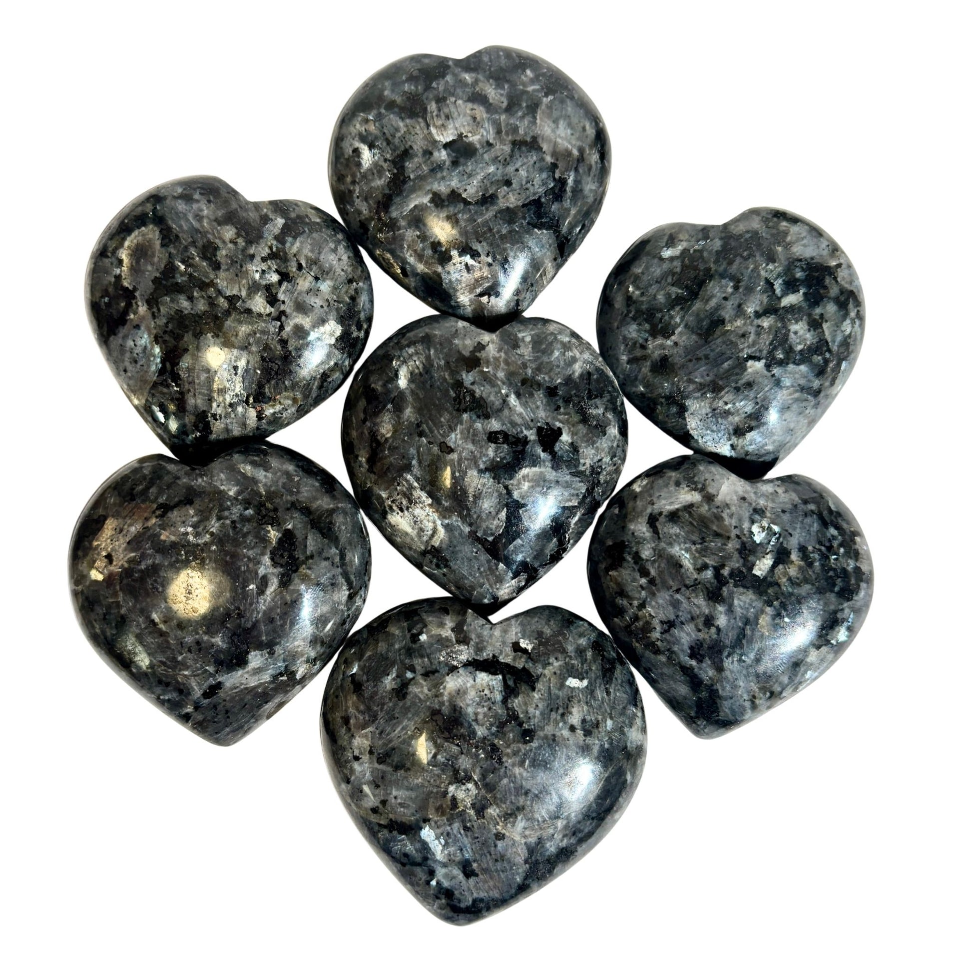 Heart-shaped gray larvikite stones on a white background