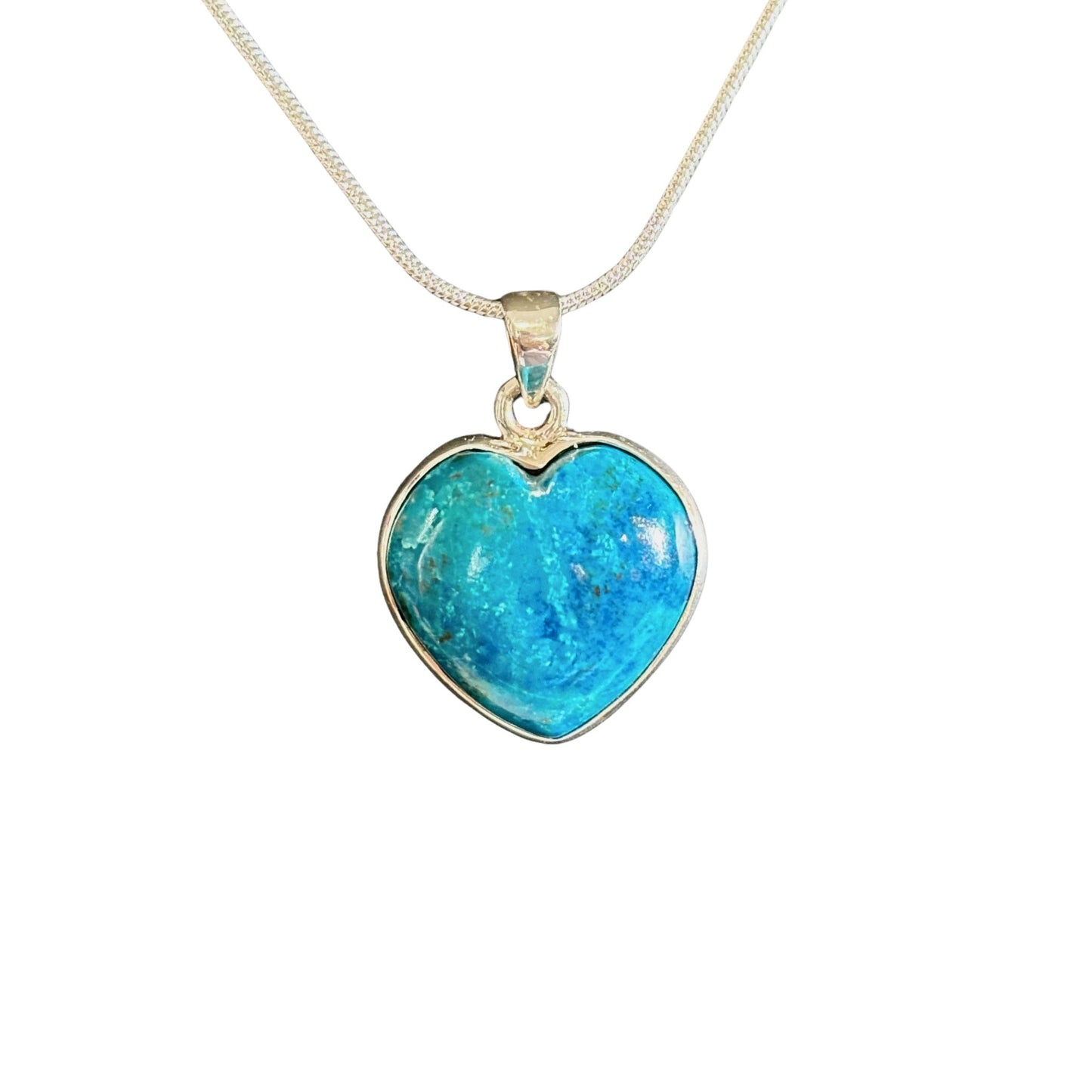 Blue shattuckite heart-shaped pendant on a silver chain against a white background